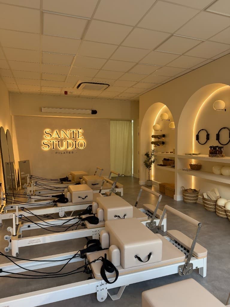 Reformer beds lined up beneath the Santé Studio sign